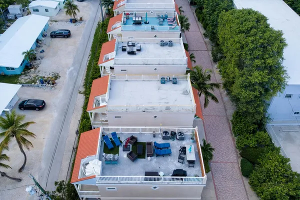 a aerial view of multiple houses with a yard