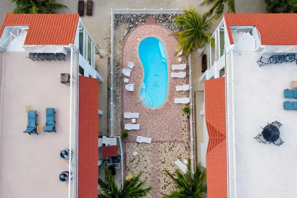 a view of a house with pool and sitting area