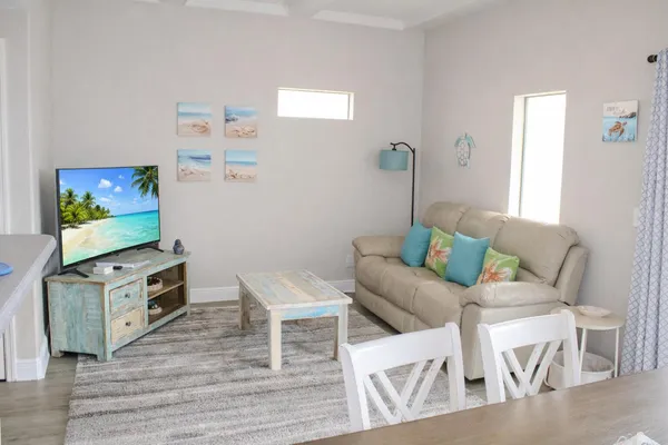 a living room with furniture and a flat screen tv