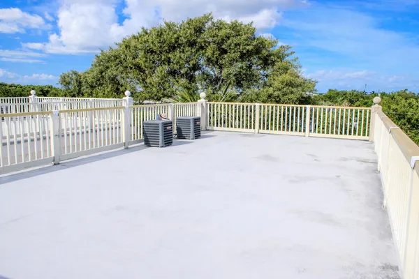 a view of a fence and trees