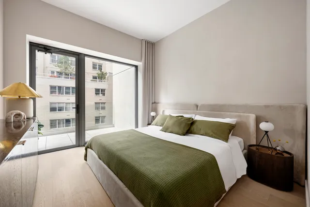 a bedroom with a large bed and a large window