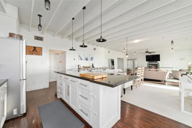 a kitchen with stainless steel appliances granite countertop a refrigerator and a stove top oven