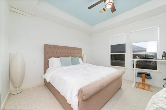 a bathroom with a granite countertop sink mirror vanity and toilet