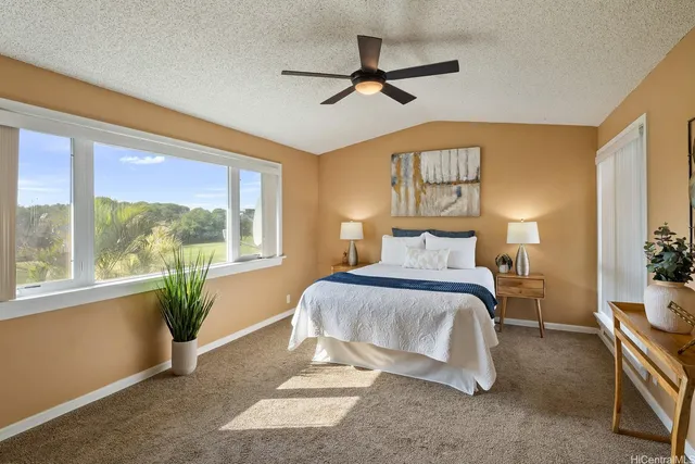 a spacious bedroom with a bed and a window