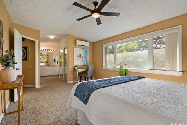 a bedroom with a bed a chandelier and large window