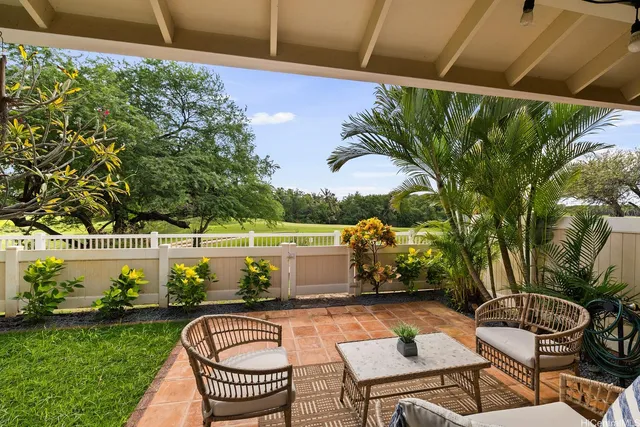 a swimming pool with outdoor seating and plants
