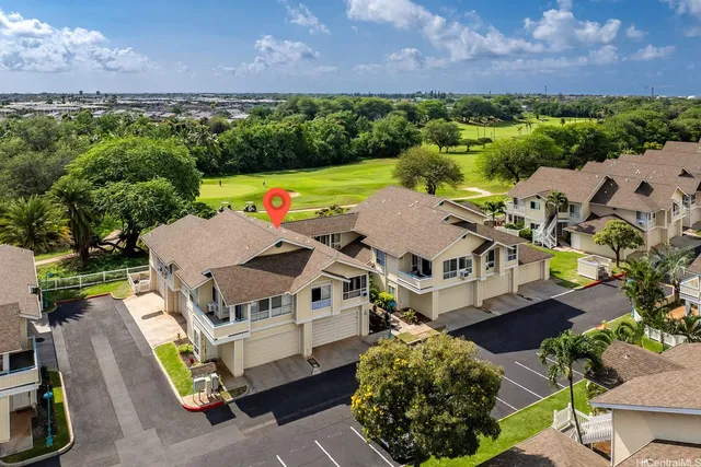 an aerial view of a house with a garden and a yard