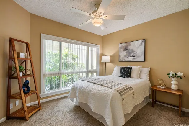 a bedroom with a bed and a painting on the wall