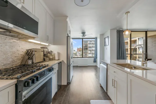 a kitchen with stainless steel appliances granite countertop a stove and a sink