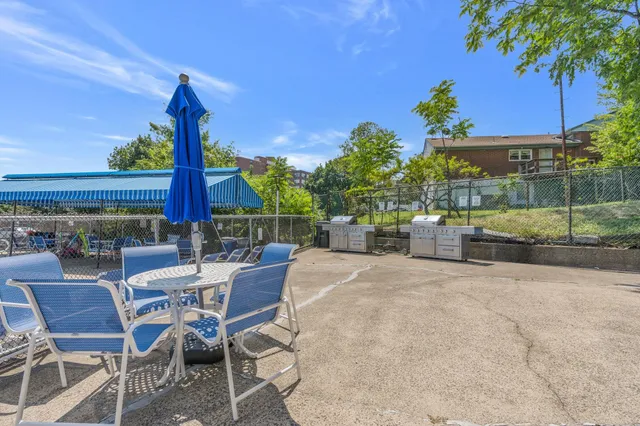 a view of swimming pool with outdoor seating and deck in the back