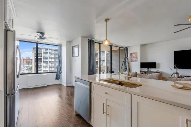 a kitchen with stainless steel appliances granite countertop a stove and a microwave