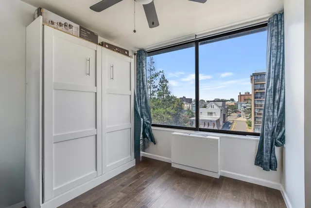 a bedroom with a large bed and a large window