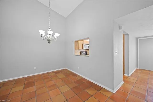 a view of a chandelier fan and entryway