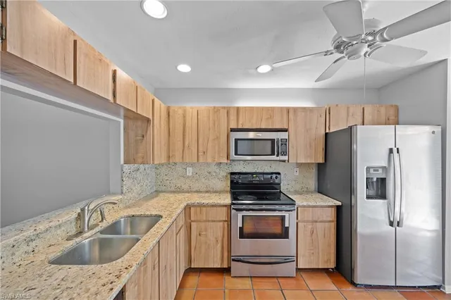 a kitchen with a sink cabinets and stainless steel appliances