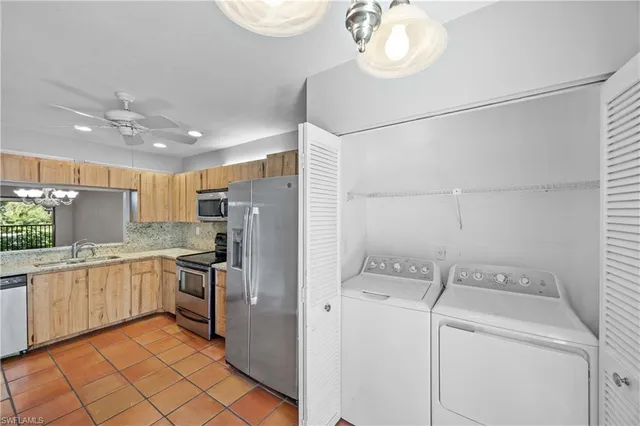 a kitchen with a stove a sink and a refrigerator