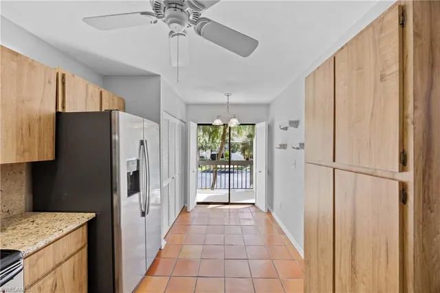 a view of a kitchen with a sink and refrigerator