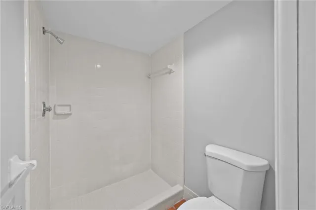 a bathroom with a toilet and shower