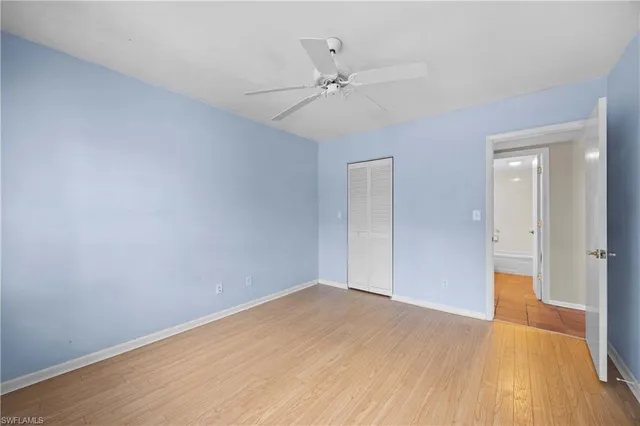 a view of a big room with wooden floor and fan in a room