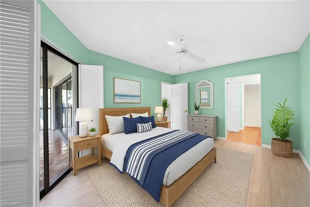 a spacious bedroom with a large bed and a potted plant