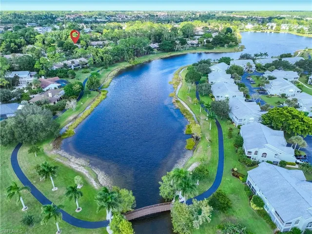 an aerial view of a house with a yard and lake view