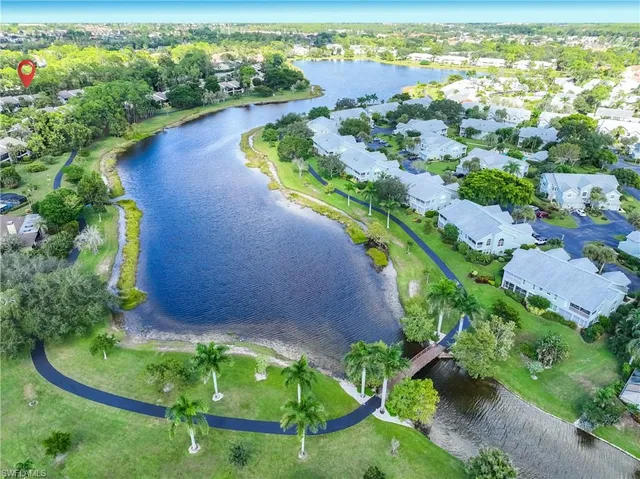 an aerial view of lake residential house with swimming pool and outdoor space