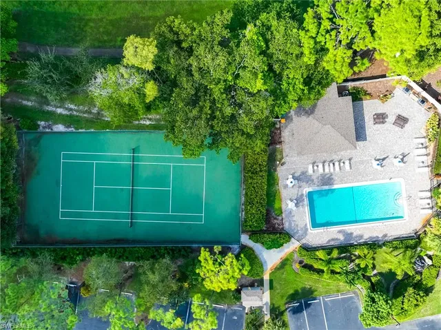 a green field with trees in the background