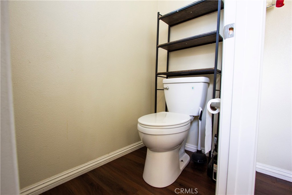 1325 Sunset Avenue Perris, CA 92571 - Photo 15 of 27 a white toilet sitting next to a small white wall