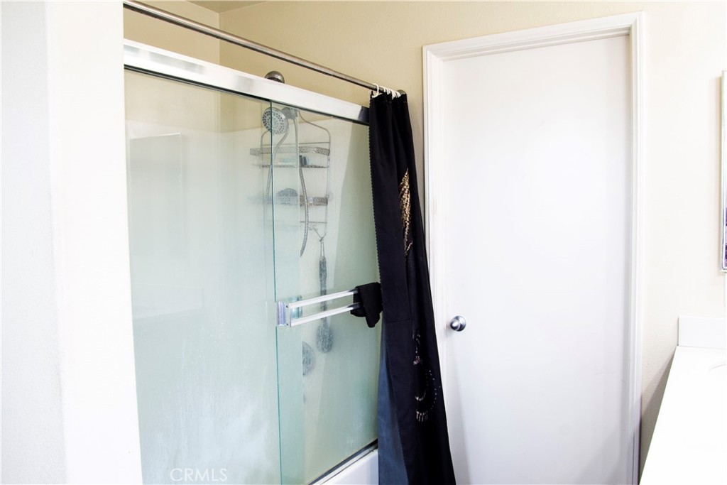 1325 Sunset Avenue Perris, CA 92571 - Photo 16 of 27 a bathroom with a glass door shower and a sink