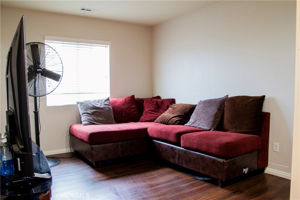 1325 Sunset Avenue Perris, CA 92571 - Photo 18 of 27 a living room with furniture a flat screen tv and a window
