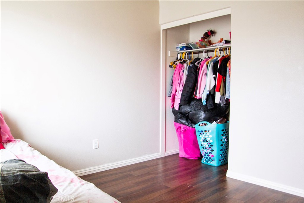 1325 Sunset Avenue Perris, CA 92571 - Photo 20 of 27 a view of walk in closet with clothes and shoes