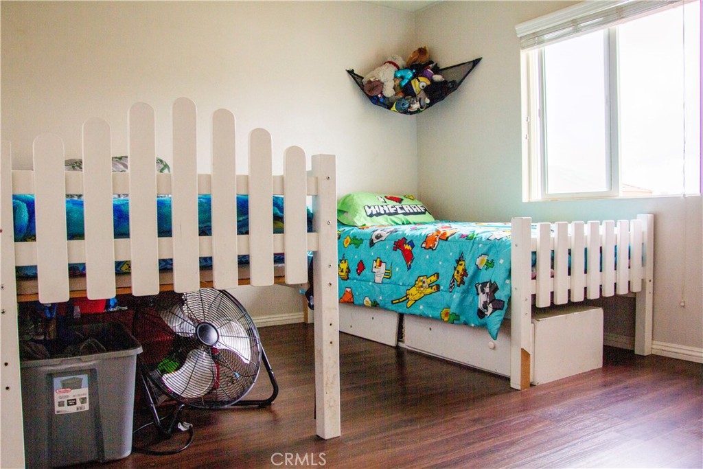 1325 Sunset Avenue Perris, CA 92571 - Photo 22 of 27 a bedroom with furniture and a wooden floor