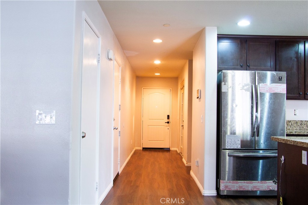 1325 Sunset Avenue Perris, CA 92571 - Photo 10 of 27 a view of a kitchen with a refrigerator and wooden floor