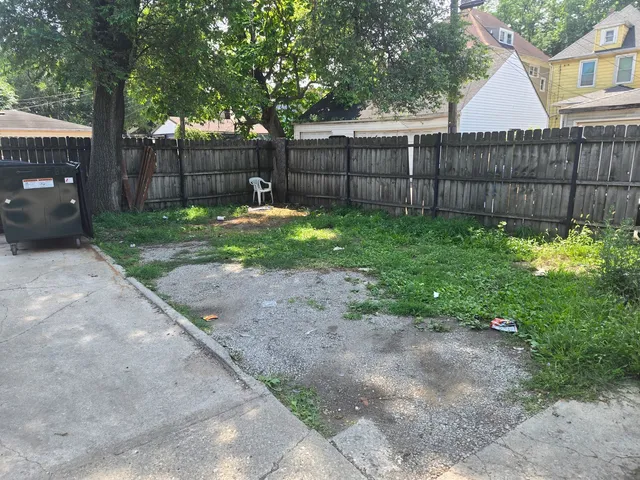 a view of a backyard with a small cabin and a chair