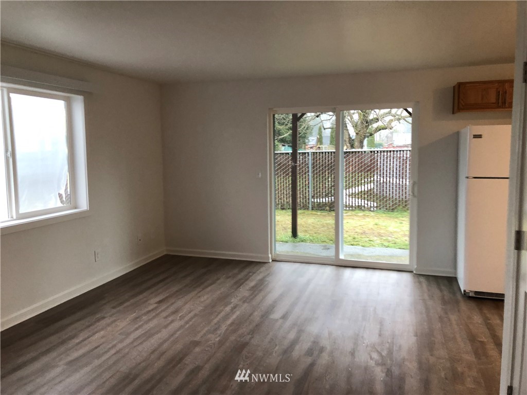 800 4th Street Sultan, WA 98294 - Photo 3 of 38 an empty room with wooden floor and windows