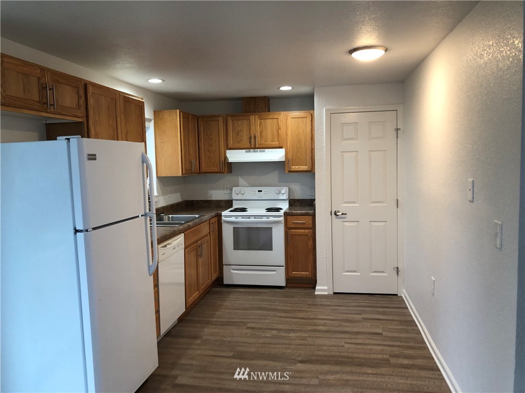 800 4th Street Sultan, WA 98294 - Photo 4 of 38 a kitchen with a refrigerator a stove top oven and cabinets