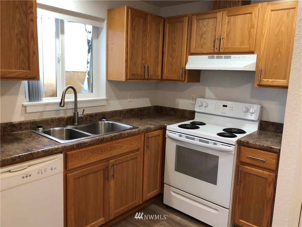 800 4th Street Sultan, WA 98294 - Photo 5 of 38 a kitchen with granite countertop white cabinets and white appliances