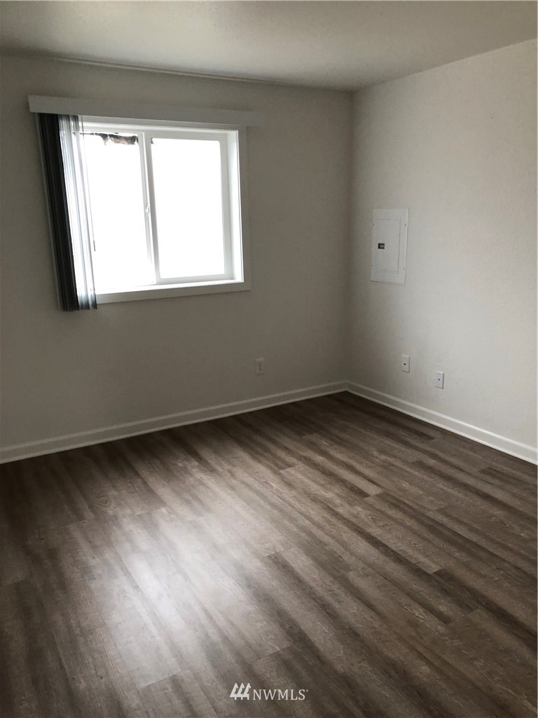 800 4th Street Sultan, WA 98294 - Photo 6 of 38 a view of an empty room with wooden floor and a window