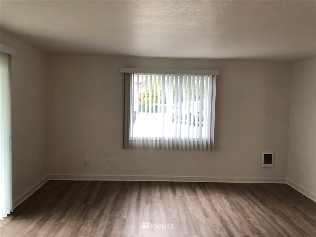 800 4th Street Sultan, WA 98294 - Photo 10 of 38 an empty room with wooden floor and windows