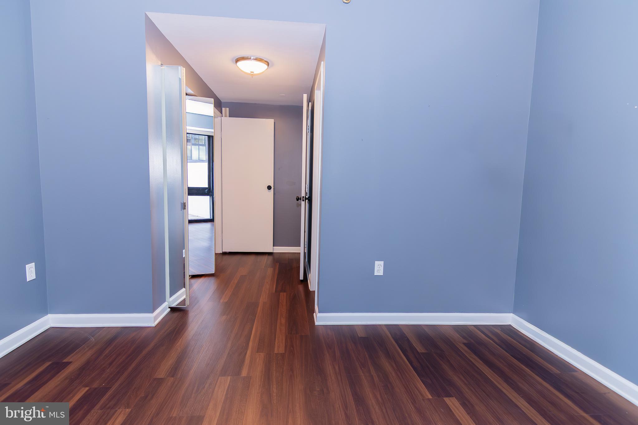 1530 Key Boulevard, Unit 205 Arlington, VA 22209 - Photo 16 of 33 a view of a room with wooden floor