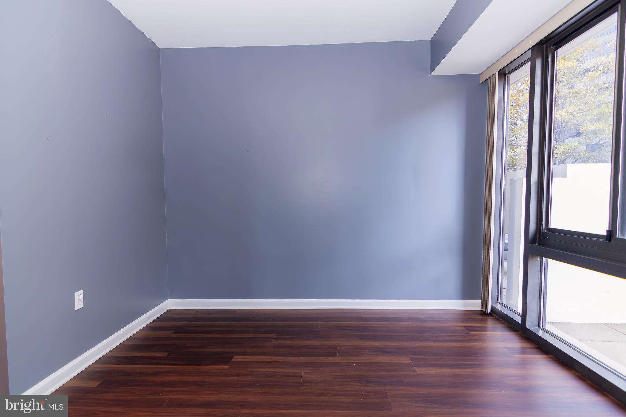 1530 Key Boulevard, Unit 205 Arlington, VA 22209 - Photo 17 of 33 a view of a room with wooden floor and large window