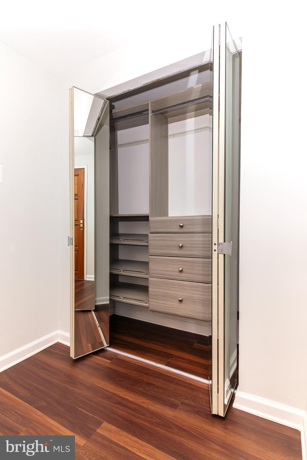 1530 Key Boulevard, Unit 205 Arlington, VA 22209 - Photo 18 of 33 a view of walk in closet with wooden floor