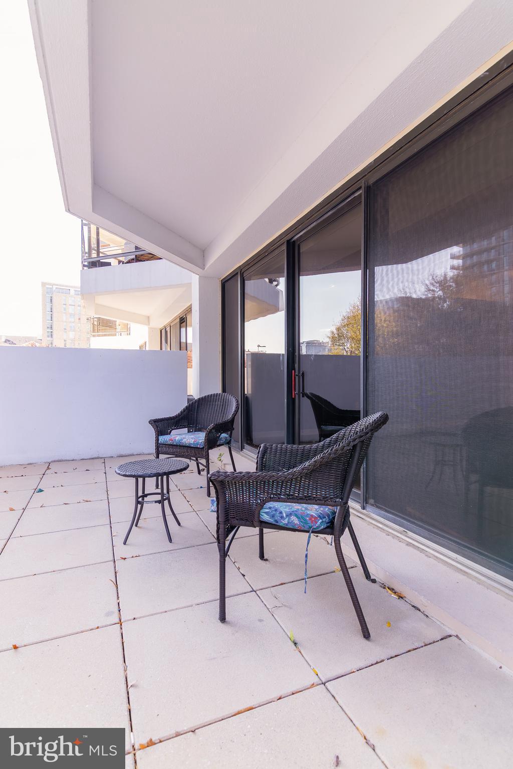 1530 Key Boulevard, Unit 205 Arlington, VA 22209 - Photo 19 of 33 a living room with furniture and a floor to ceiling window