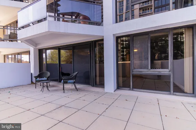 a view of a building with sitting area and furniture