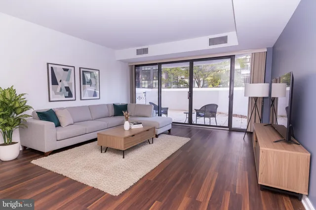 a view of a room with wooden floor and window