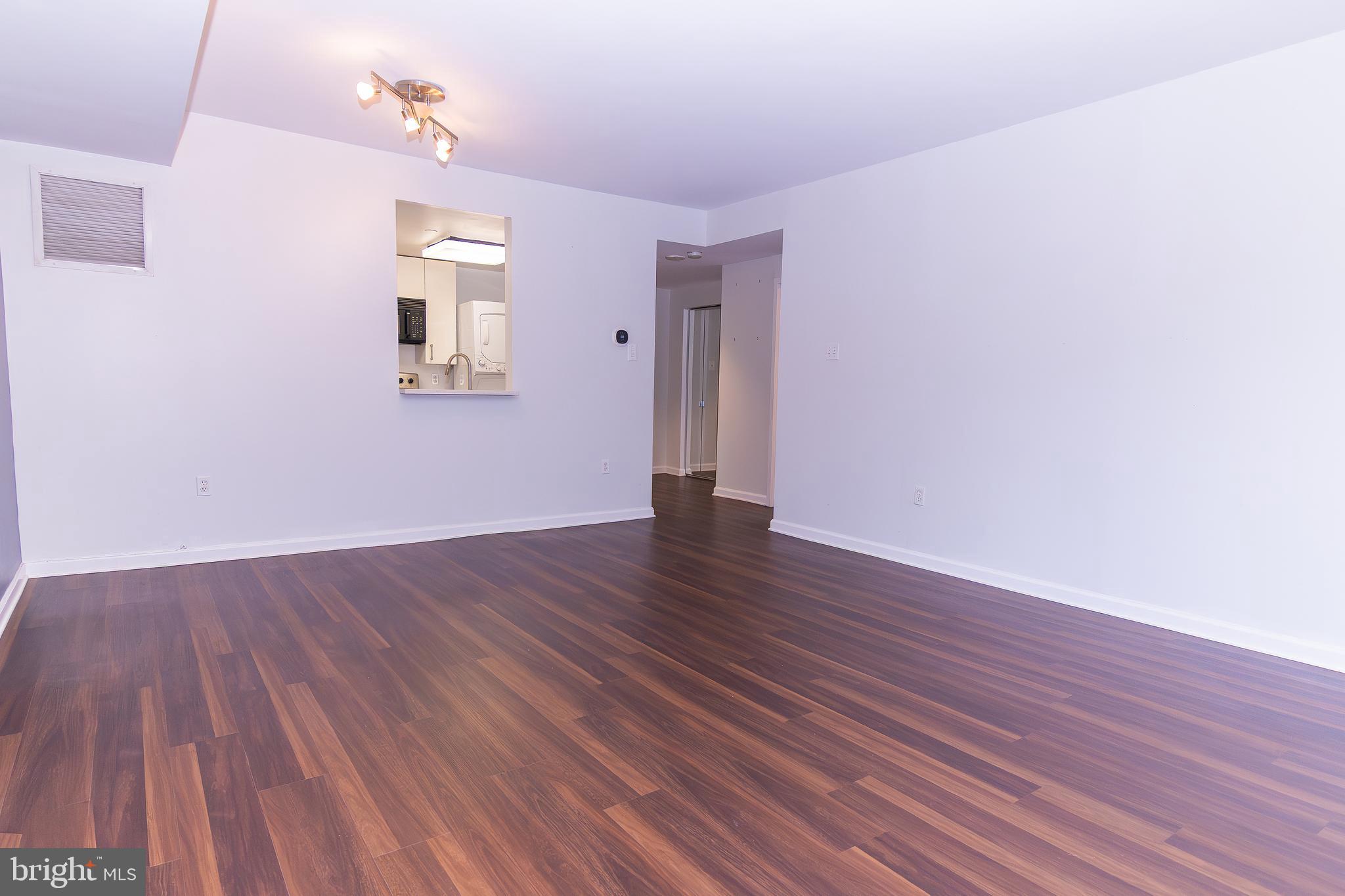 1530 Key Boulevard, Unit 205 Arlington, VA 22209 - Photo 25 of 33 a view of a room with wooden floor and window