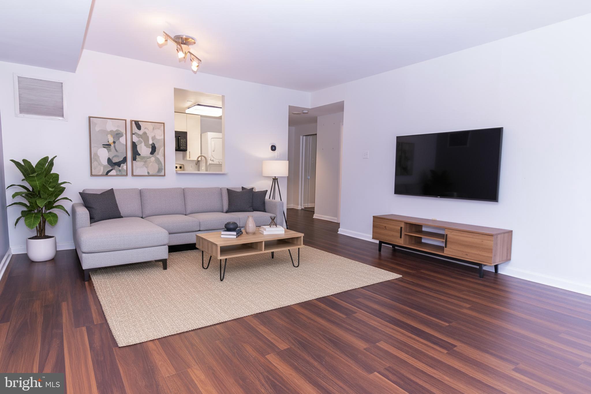 1530 Key Boulevard, Unit 205 Arlington, VA 22209 - Photo 26 of 33 a living room with furniture and a flat screen tv