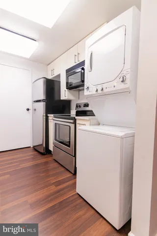 a kitchen with a sink cabinets and a window
