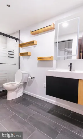 a bathroom with a toilet and a shower