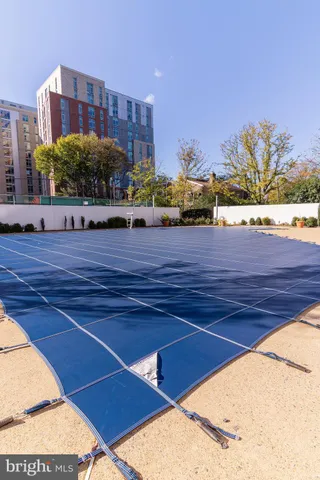 a living room with a bed furniture and a large window