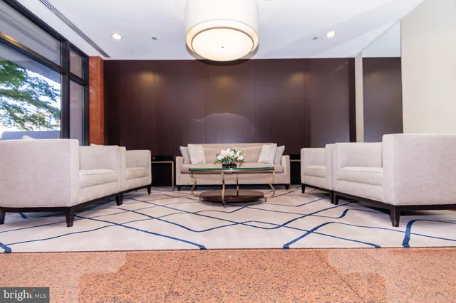 a living room with furniture a flat screen tv and a large window